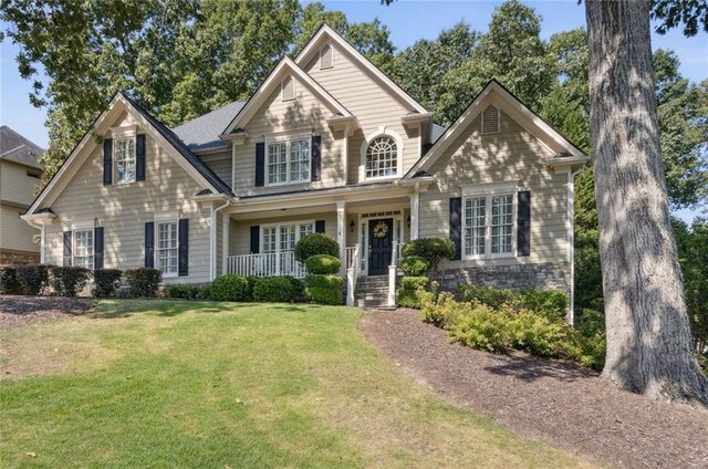 rear view of property with a deck and a patio area