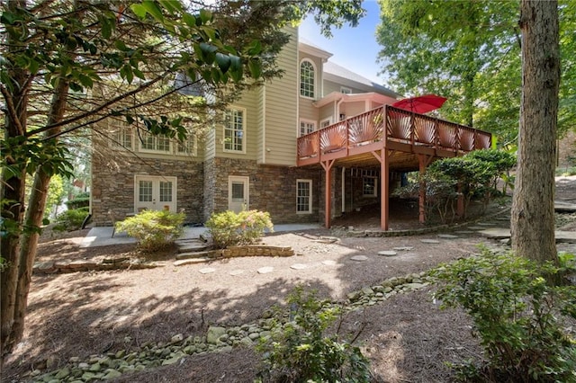 back of property with a wooden deck