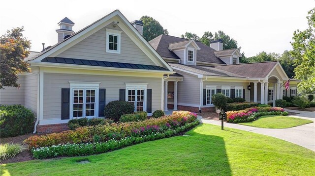 surrounding community featuring tennis court and a lawn