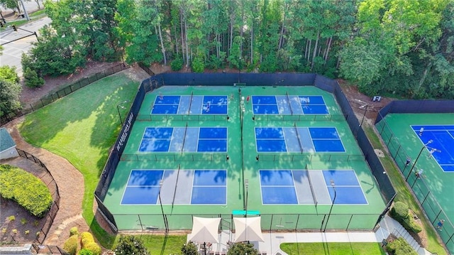 view of tennis court featuring a lawn