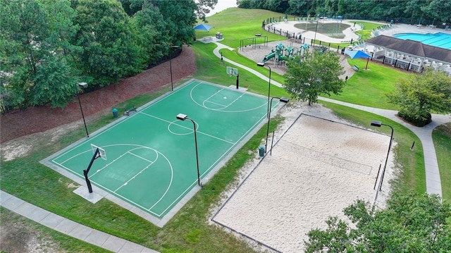 view of sport court featuring a playground, volleyball court, and a lawn