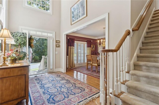 foyer with a high ceiling and light wood-type flooring