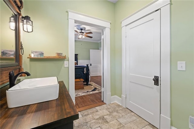 315 W Ave, Cartersville, GA 30120 - bathroom featuring stone finish flooring, a ceiling fan, baseboards, and a sink
