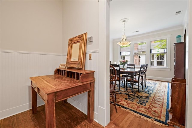 315 W Ave, Cartersville, GA 30120 - dining space featuring wood finished floors, ornamental molding, a wainscoted wall, and baseboards