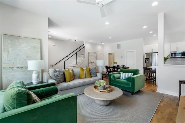 living room with ceiling fan and hardwood / wood-style floors