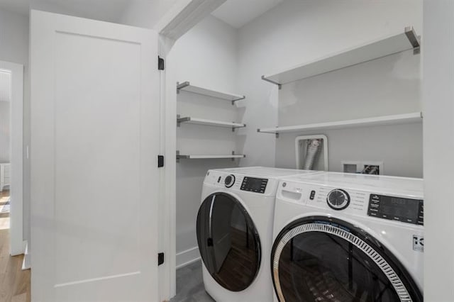 washroom featuring washer and clothes dryer