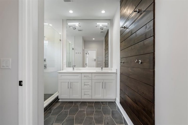 bathroom with walk in shower, tile patterned floors, and vanity