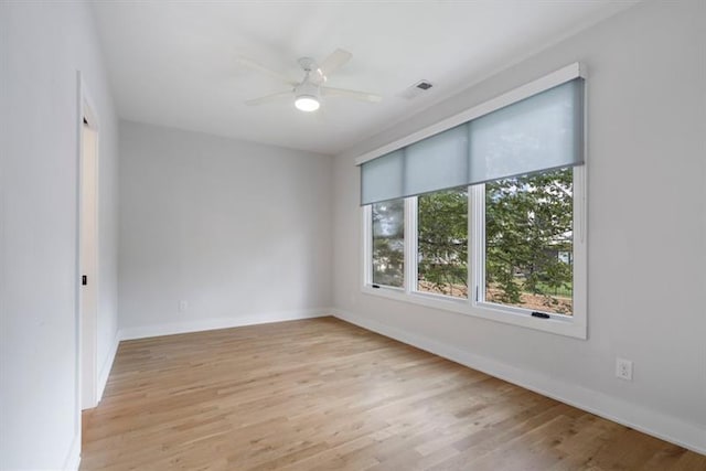 unfurnished room with ceiling fan and light wood-type flooring