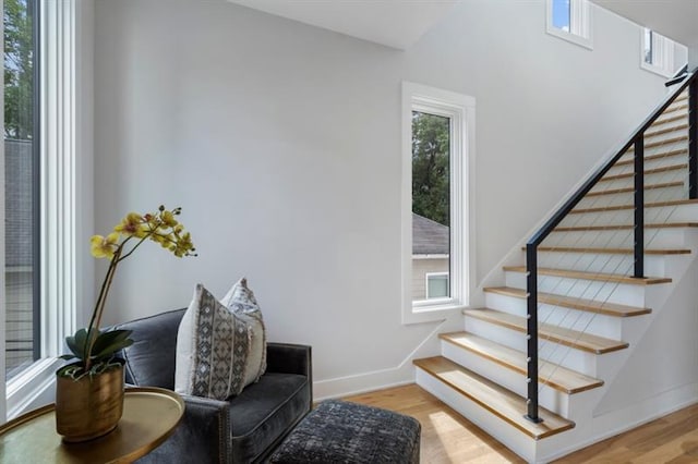 stairs featuring hardwood / wood-style floors