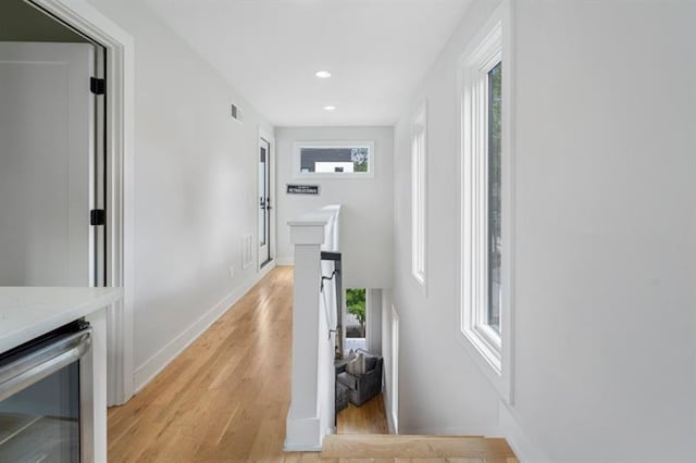 hall featuring light wood-type flooring and wine cooler