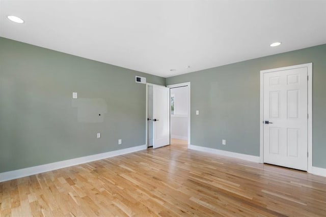 unfurnished room with light hardwood / wood-style flooring