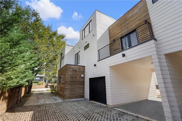 view of side of home featuring a garage