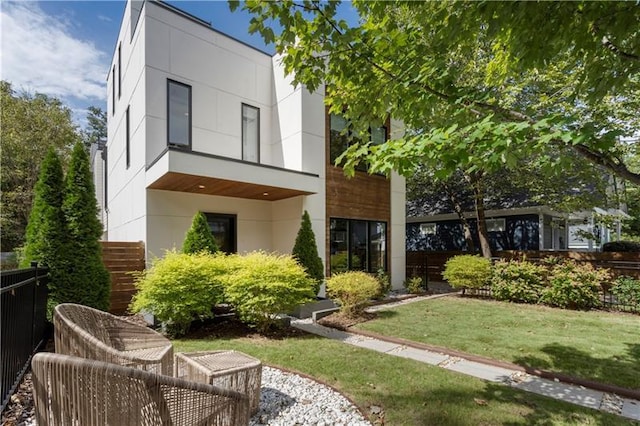 rear view of property featuring a lawn