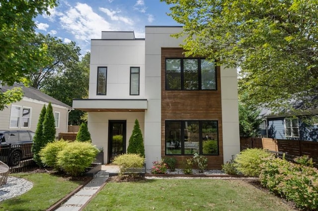 modern home featuring a front lawn