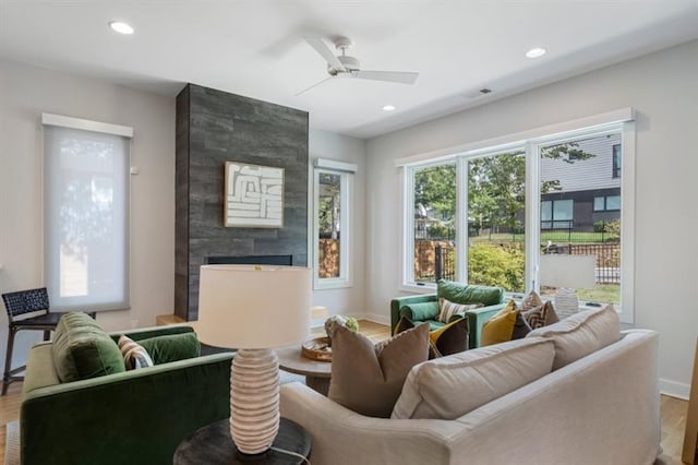 living room featuring ceiling fan and hardwood / wood-style floors