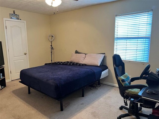 carpeted bedroom featuring a textured ceiling