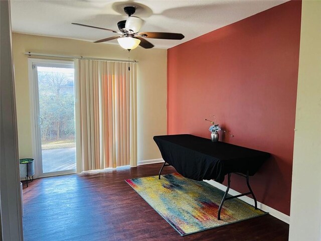 interior space with ceiling fan and dark hardwood / wood-style flooring