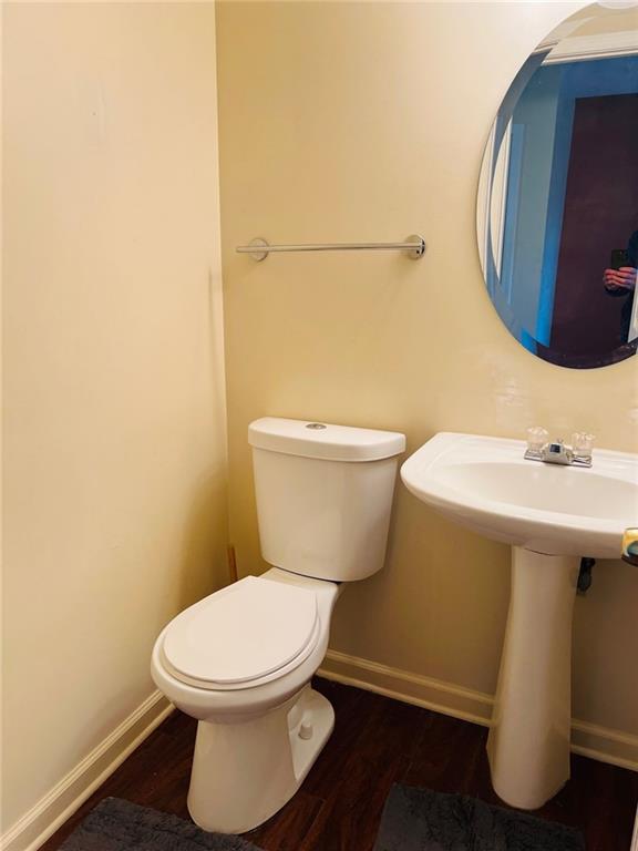 bathroom featuring hardwood / wood-style flooring and toilet