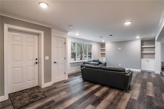 living room featuring ornamental molding, dark wood-type flooring, built in features, and ceiling fan