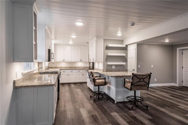 kitchen featuring white cabinetry, appliances with stainless steel finishes, light stone countertops, and sink