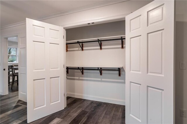 bathroom featuring wood-type flooring, tile walls, vanity, ornamental molding, and tiled shower