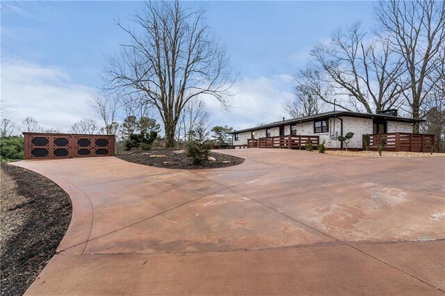 back of property featuring cooling unit, a patio, and a fire pit