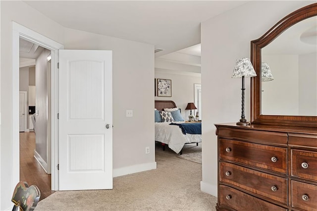 bedroom featuring baseboards and light carpet