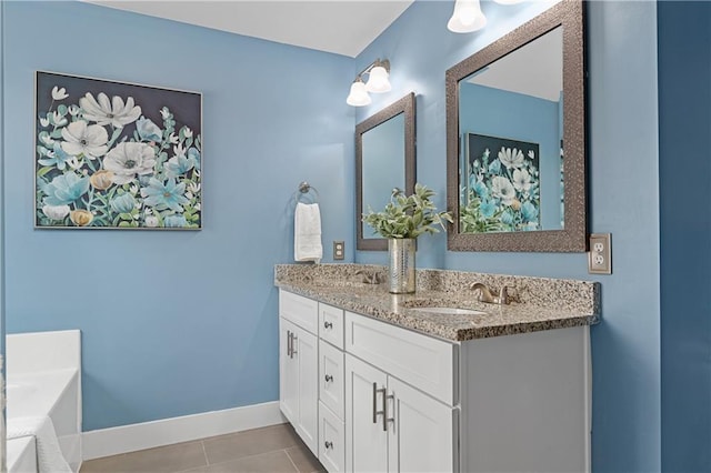 full bathroom with tile patterned floors, a sink, double vanity, baseboards, and a bath