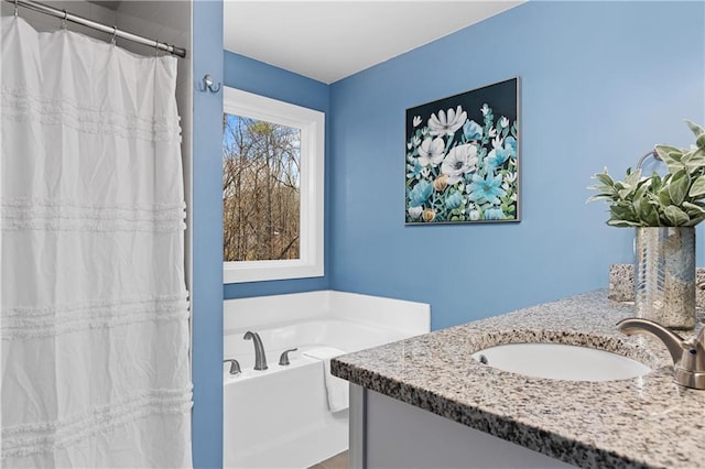 full bathroom with vanity, a shower with shower curtain, and a garden tub