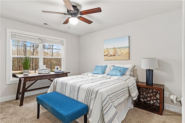 carpeted bedroom featuring visible vents, ceiling fan, and baseboards