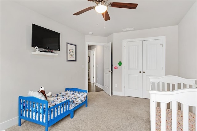 bedroom featuring a closet, visible vents, carpet flooring, and baseboards