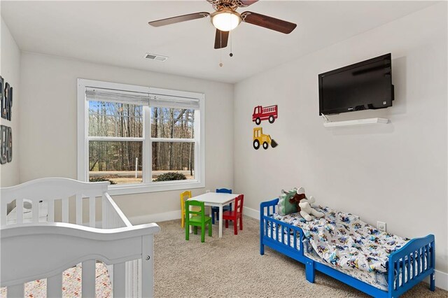 bedroom featuring a ceiling fan, carpet flooring, baseboards, and visible vents