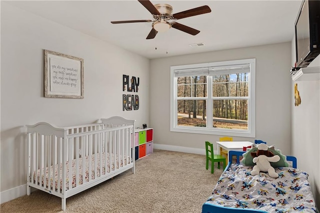 carpeted bedroom featuring visible vents, baseboards, and a ceiling fan