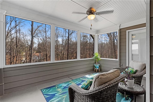 unfurnished sunroom with a wealth of natural light and a ceiling fan