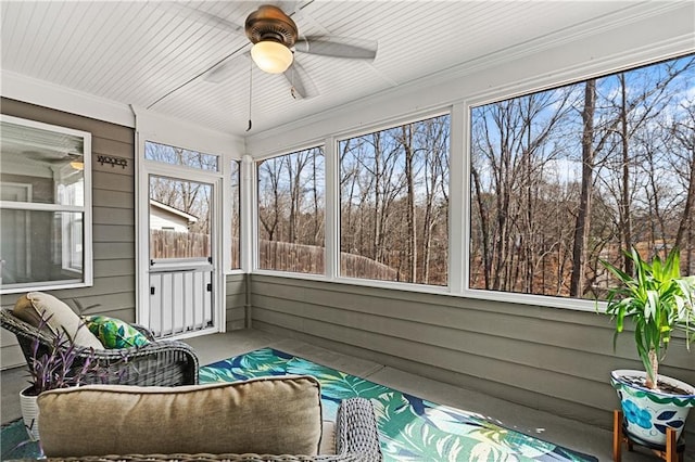 sunroom featuring ceiling fan