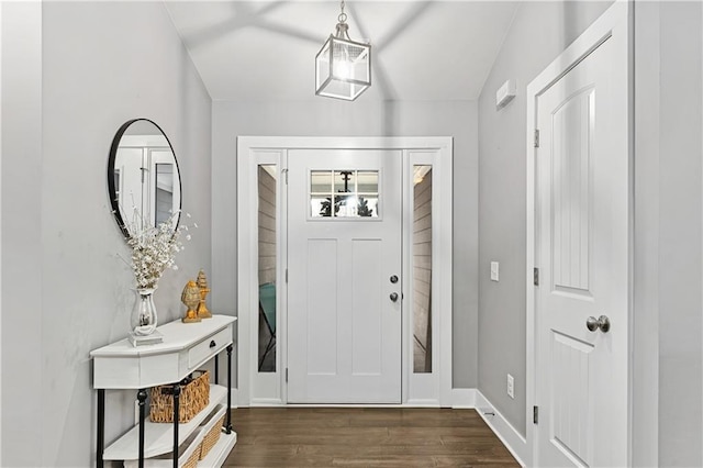 foyer entrance featuring dark wood finished floors and baseboards