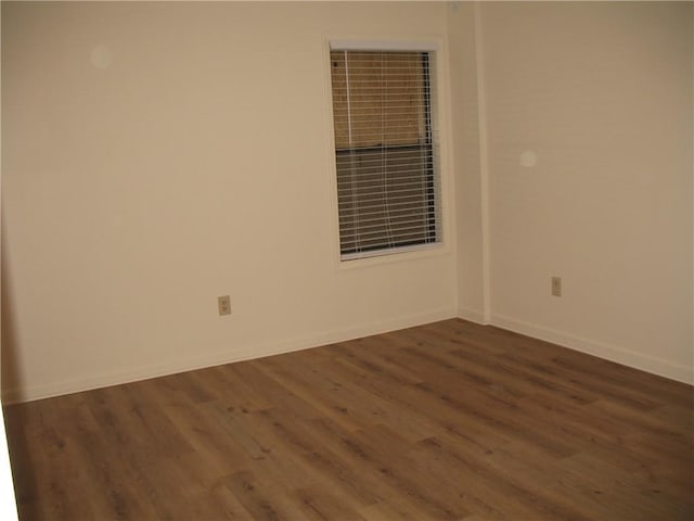 unfurnished room featuring dark wood-type flooring