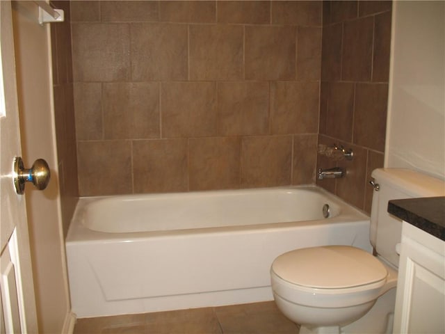 full bathroom featuring toilet, vanity, tiled shower / bath combo, and tile patterned flooring