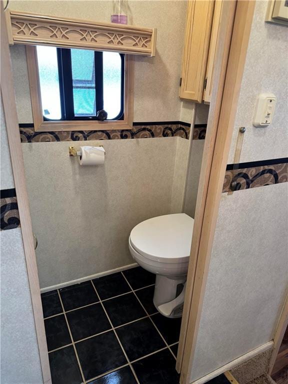 bathroom with tile patterned flooring and toilet