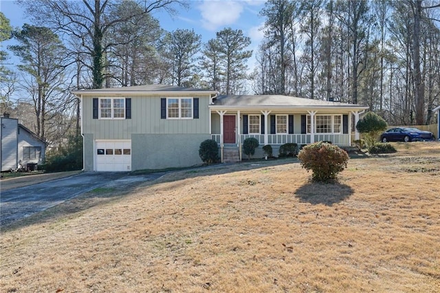 split level home with covered porch and a garage