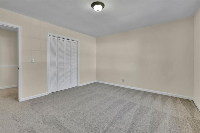 unfurnished bedroom featuring carpet flooring and a closet