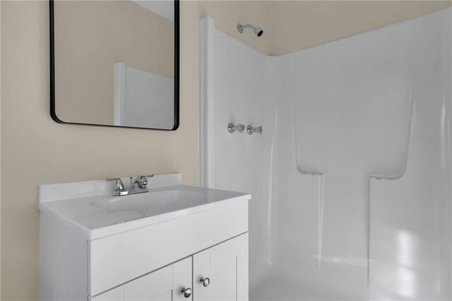 bathroom featuring vanity and a shower