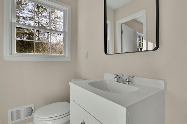 bathroom with vanity and toilet