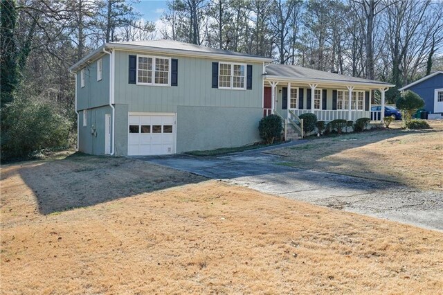 view of front of home featuring a porch and a garage