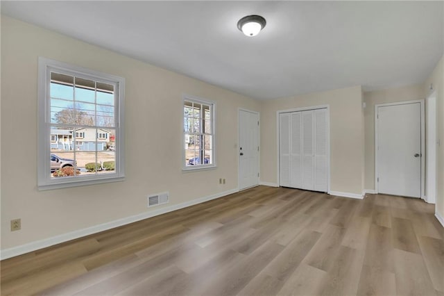 unfurnished bedroom with light wood-type flooring