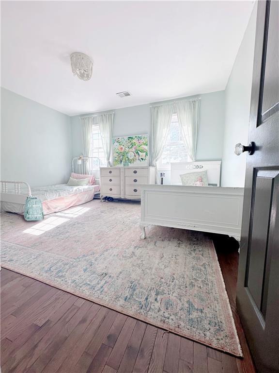 bedroom with dark hardwood / wood-style floors