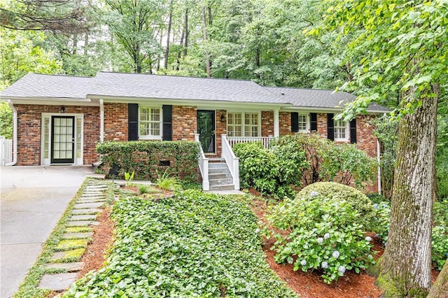 2197 Fairway Cir NE, Brookhaven, GA 30319 - ranch-style home featuring brick siding, concrete driveway, and roof with shingles
