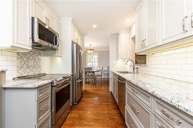 2197 Fairway Cir NE, Brookhaven, GA 30319 - kitchen with appliances with stainless steel finishes, a sink, tasteful backsplash, light stone counters, and crown molding
