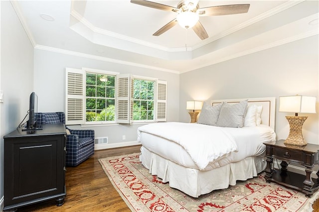 2197 Fairway Cir NE, Brookhaven, GA 30319 - bedroom with a tray ceiling, dark wood-type flooring, crown molding, a ceiling fan, and baseboards