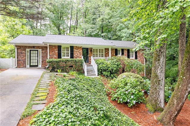 2197 Fairway Cir NE, Brookhaven, GA 30319 - ranch-style home featuring driveway, brick siding, and covered porch